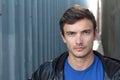 Portrait of young man outdoors with very handsome face in casual clothes against alley way urban background Royalty Free Stock Photo