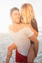 Portrait of a young man piggybacking beautiful woman Royalty Free Stock Photo