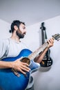 Portrait of young man playing on acoustic guitar at studio Royalty Free Stock Photo