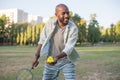 Portrait of young man playing badminton in public park Royalty Free Stock Photo