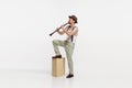 Portrait of young man playing clarinet isolated over white studio background. Expressive performance Royalty Free Stock Photo