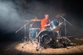 Portrait of young man playing drum set in studio with smoke Royalty Free Stock Photo