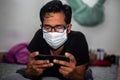 Portrait of a young man playing Mobile video games at Night deu to coronavirus epidemic Royalty Free Stock Photo