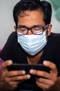 Portrait of a young man playing Mobile video games at Night deu to coronavirus epidemic Royalty Free Stock Photo