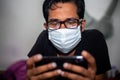 Portrait of a young man playing Mobile video games at Night deu to coronavirus epidemic Royalty Free Stock Photo