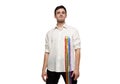 Portrait of young man posing in white shirt with rainbow, lgbt flag against white background. Looking proud and