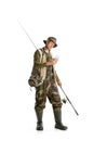 Portrait of young man, professional fishman with fishing rod, spinning and equipment going to river isolated over white