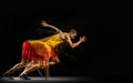 Portrait of young man, professional male athlete, runner in motion and action isolated on dark background. Stroboscope