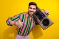 Portrait of young man promoting oldschool boombox cassette recorder thumb up photosession with old props isolated on Royalty Free Stock Photo