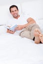 Portrait Of Young Man Reading Book On Bed Royalty Free Stock Photo