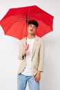 portrait of a young man red umbrella a man in a light jacket isolated background unaltered Royalty Free Stock Photo