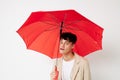 portrait of a young man red umbrella a man in a light jacket isolated background unaltered Royalty Free Stock Photo