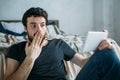 Portrait of a young man relaxing and watching a TV show on a tablet computer Royalty Free Stock Photo