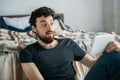 Portrait of a young man relaxing and watching a TV show on a tablet computer Royalty Free Stock Photo