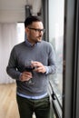 Portrait of man sad and depressed standing at window in despair at home Royalty Free Stock Photo