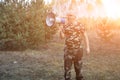 Portrait of a young man screaming with a megaphone in the forest. Lost People Search Concept