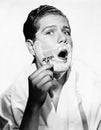 Portrait of a young man shaving Royalty Free Stock Photo