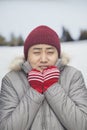 Portrait of young man shivering in cold temperature in big coat Royalty Free Stock Photo