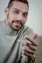 Portrait of a young man with a short beard speaks gesturing with his hands to explain something Royalty Free Stock Photo