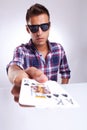 Portrait of young man showing poker cards