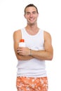 Portrait of young man showing sun screen creme Royalty Free Stock Photo