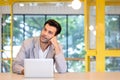 Portrait of young man sitting at his desk in the Modern office, Focused businessman working laptop thinking Royalty Free Stock Photo