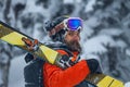 Portrait young man ski goggles holding ski in the mountains Royalty Free Stock Photo