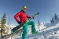 Portrait young man ski goggles holding ski in the mountains Royalty Free Stock Photo