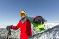 Portrait young man ski goggles holding ski in the mountains Royalty Free Stock Photo