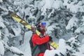 Portrait young man ski goggles holding ski in the mountains Royalty Free Stock Photo