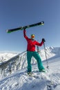 Portrait young man ski goggles holding ski in the mountains Royalty Free Stock Photo