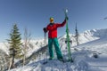 Portrait young man ski goggles holding ski in the mountains Royalty Free Stock Photo