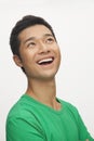 Portrait of young man smiling in a green shirt, white background Royalty Free Stock Photo