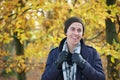 Portrait of a young man smiling outdoors in jacket gloves hat scarf Royalty Free Stock Photo