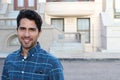 Portrait of a young man smiling with urban background and copy space Royalty Free Stock Photo