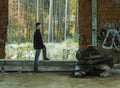 Portrait of young man stand in abandoned building hydraulic tool