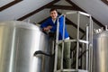 Portrait of young man standing by storage tank Royalty Free Stock Photo