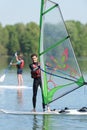 portrait young man standing on wind surfing board Royalty Free Stock Photo