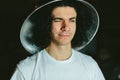 Portrait of a young man in strange unusual hat