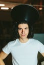 Portrait of a young man in strange unusual hat