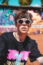 Portrait of a young man with sunglasses against graffiti background outdoors Royalty Free Stock Photo
