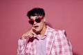 portrait of a young man sunglasses pink blazer fashion elegant style isolated background unaltered Royalty Free Stock Photo