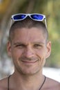 Portrait of a young man with sunglasses resting on the beach, close up Royalty Free Stock Photo