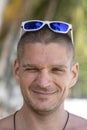 Portrait of a young man with sunglasses resting on the beach, close up Royalty Free Stock Photo