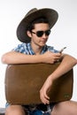 Portrait of young man in sunglasses with a suitcase. Royalty Free Stock Photo