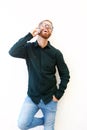 Young man talking on phone and laughing against white background Royalty Free Stock Photo