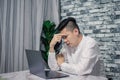 Portrait of young man thinking while serious working  at home with laptop on desk Royalty Free Stock Photo