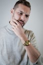 Portrait of a young man touching his chin in a moment of doubt or reflection Royalty Free Stock Photo