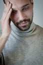 Portrait of a young man touching his forehead to focus or because of an headache Royalty Free Stock Photo