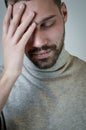 Portrait of a young man touching his forehead to focus or because of an headache Royalty Free Stock Photo